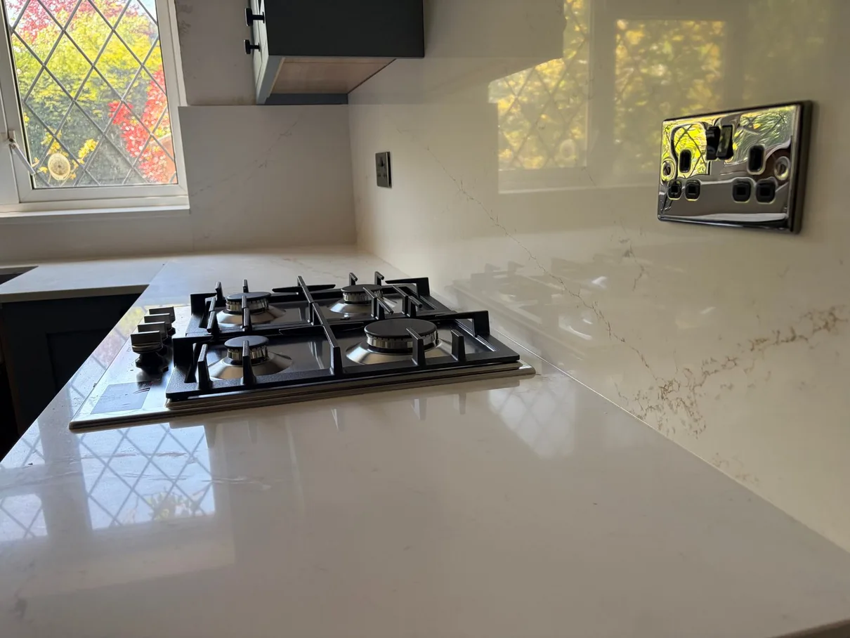 Kitchen rewiring — chrome double socket on quartz splashback