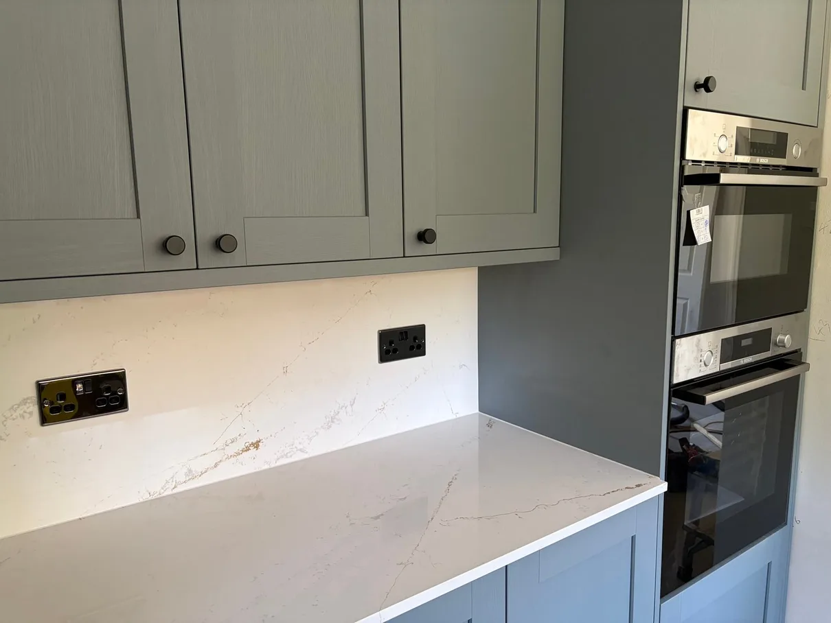 Kitchen rewiring — black sockets on quartz worktop upstand