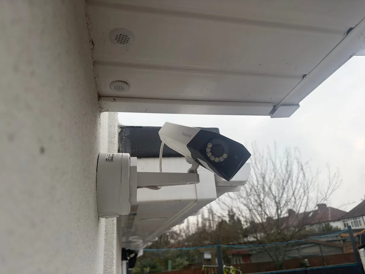 Reolink bullet CCTV camera on wall corner — North London