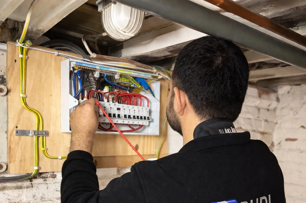 Rudi carrying out electrical tests at an open consumer unit