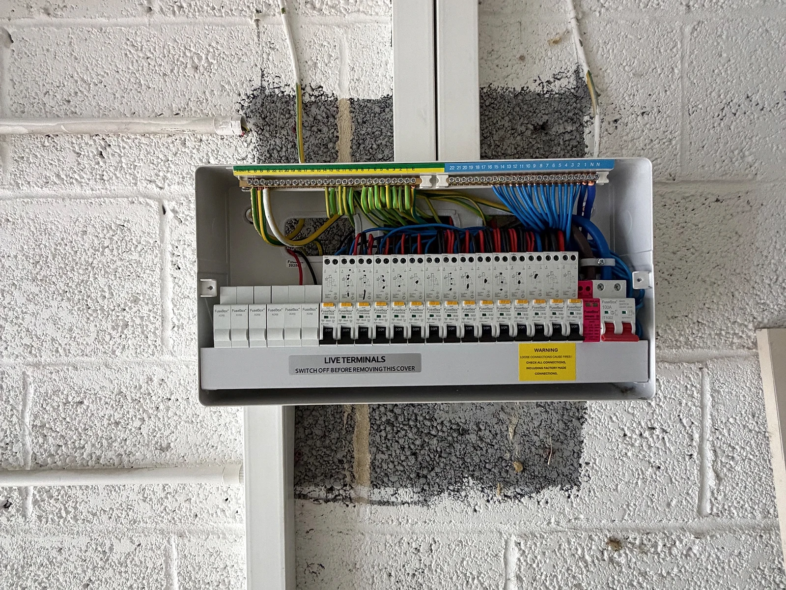 Open consumer unit with neatly arranged circuits during a whole-house rewire