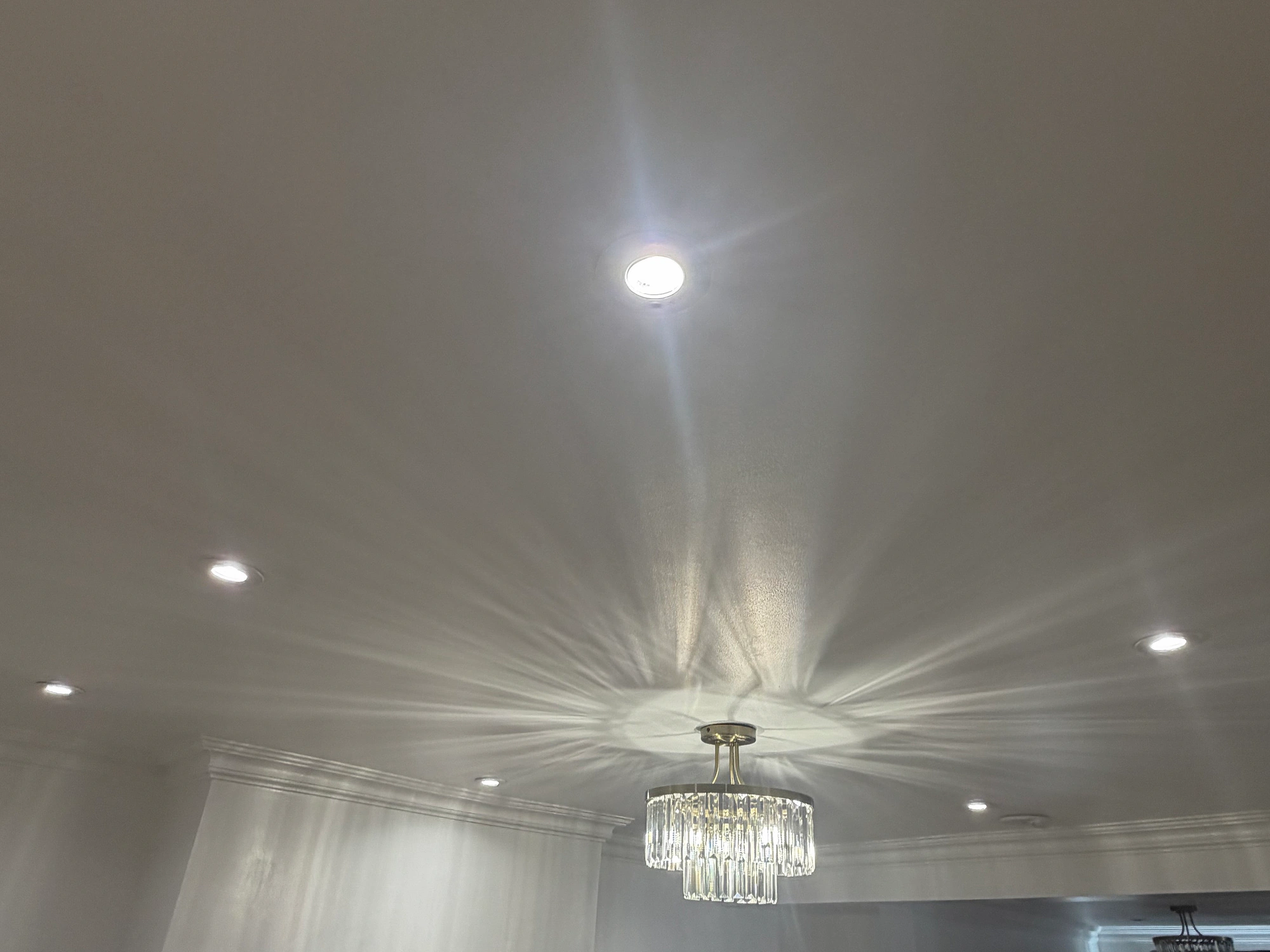 Completed North London room with downlights and a feature pendant illuminated