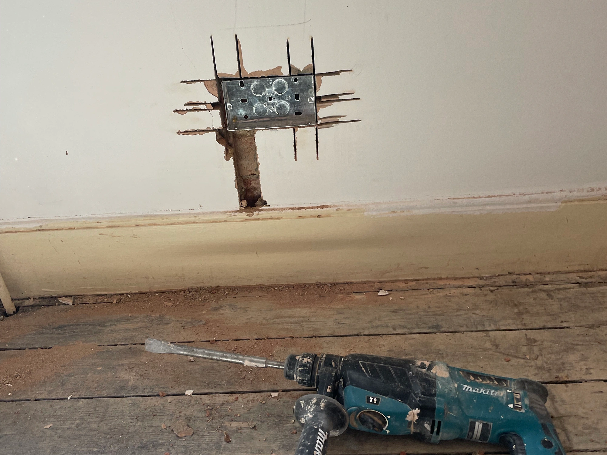 Metal back box and wall chase prepared during a North London house rewire