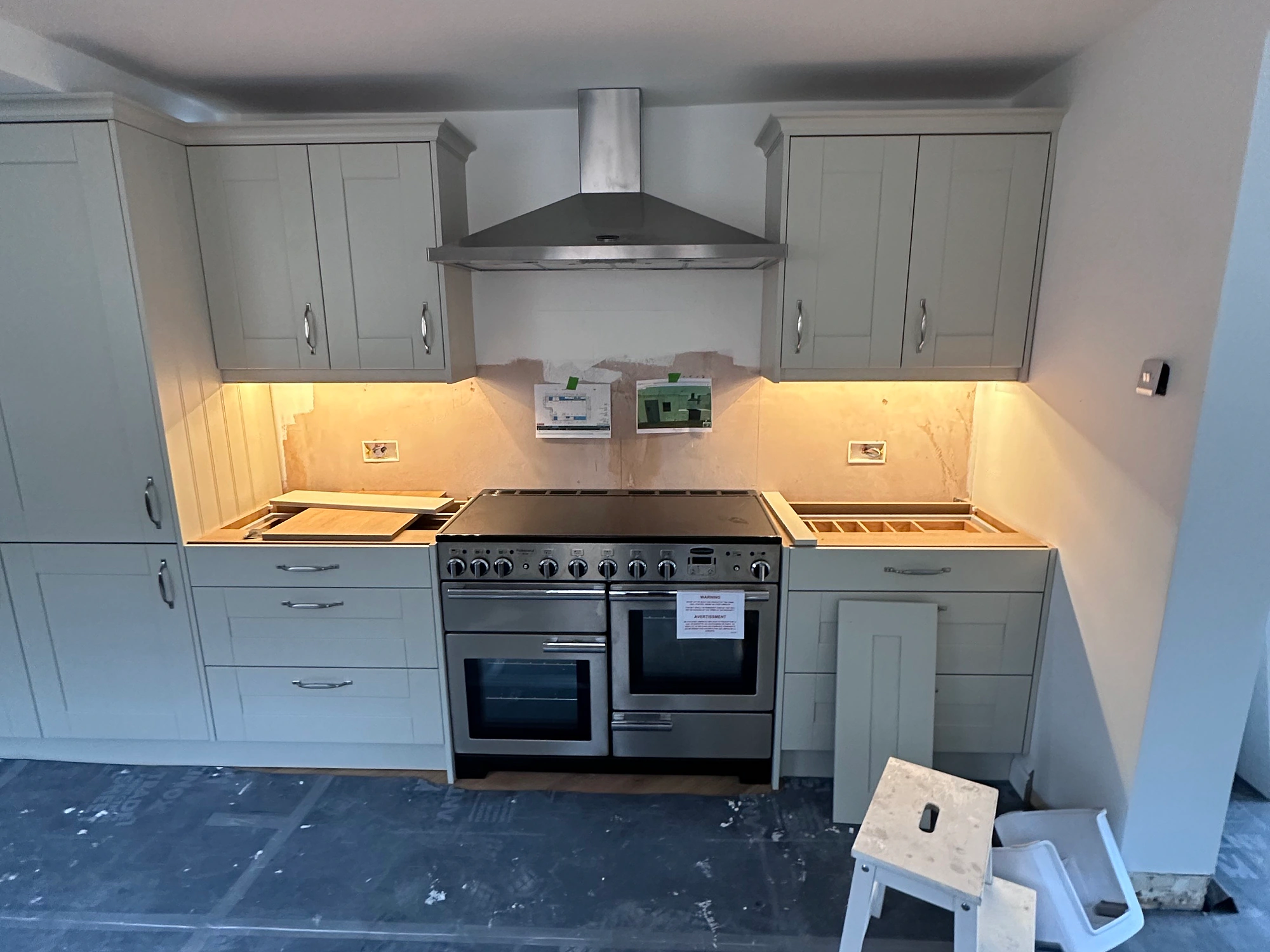 Kitchen electrical fit-out in progress with appliance points and work lighting visible
