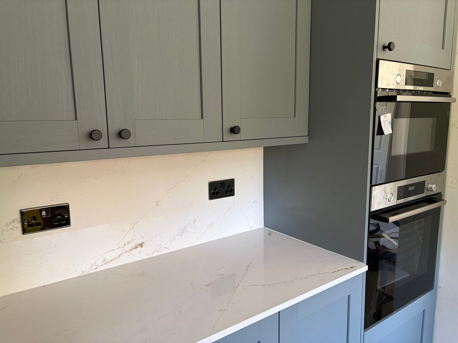 Kitchen rewiring — black sockets on quartz worktop upstand