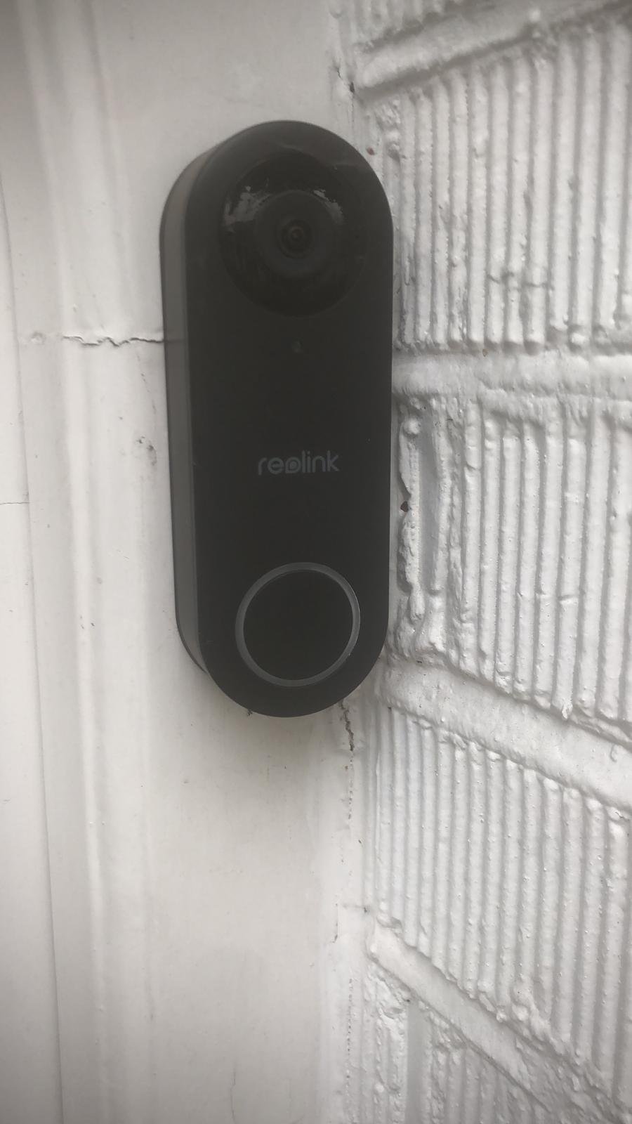 Reolink video doorbell installed on door frame — North London