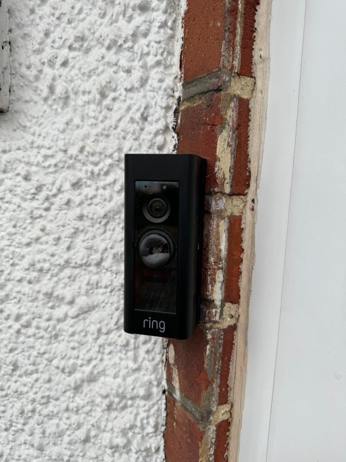 Ring video doorbell on brick wall — North London