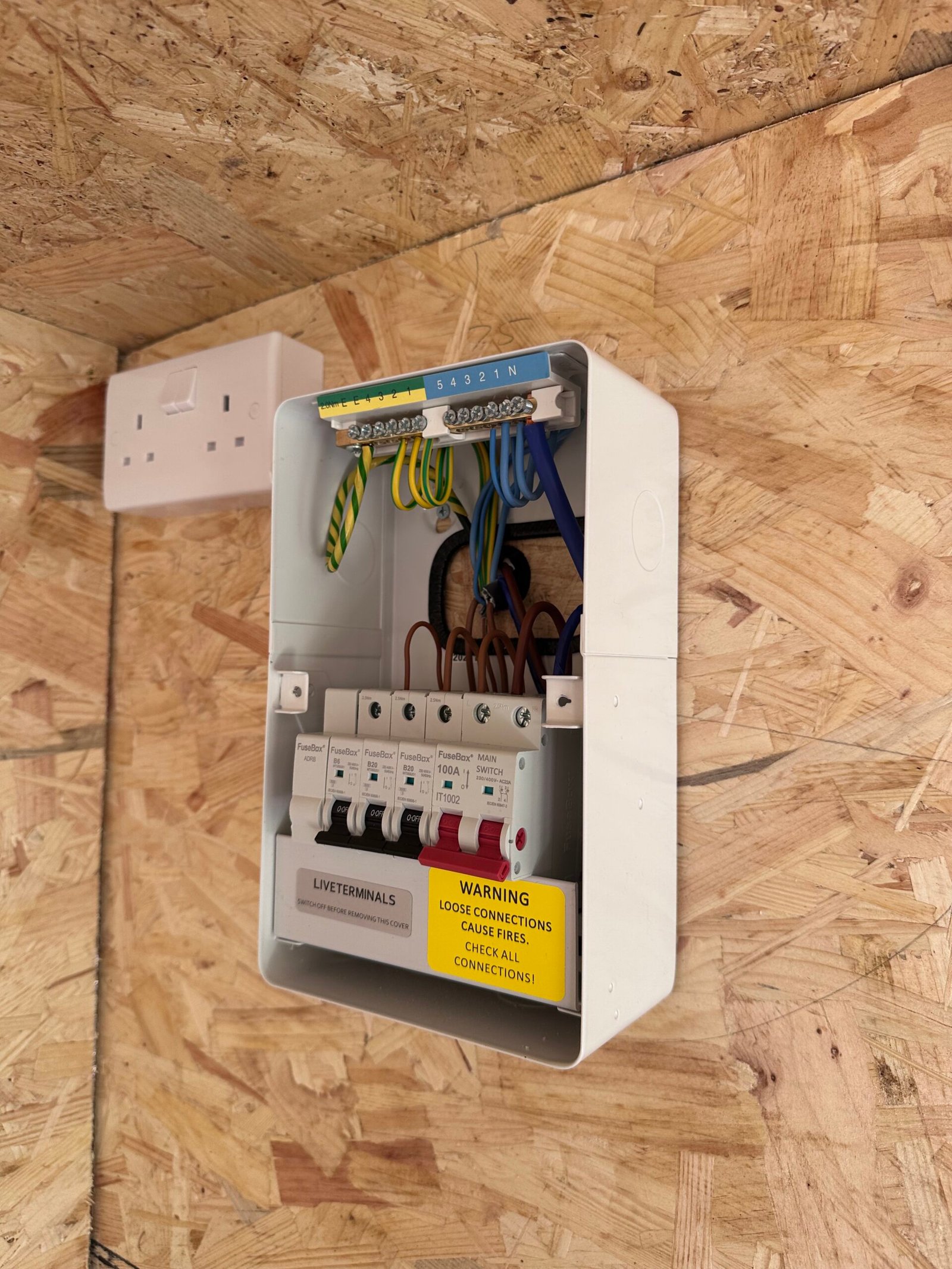 CCTV bullet camera on rendered wall — North London